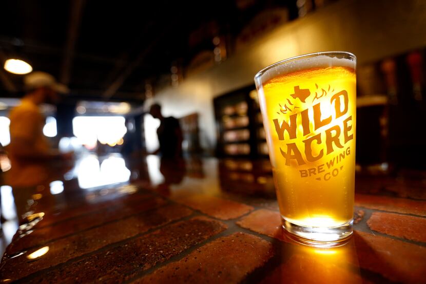 A glass of Moonlight Shine beer made by Wild Acre Brewing Co. sits on the bar in the taproom...