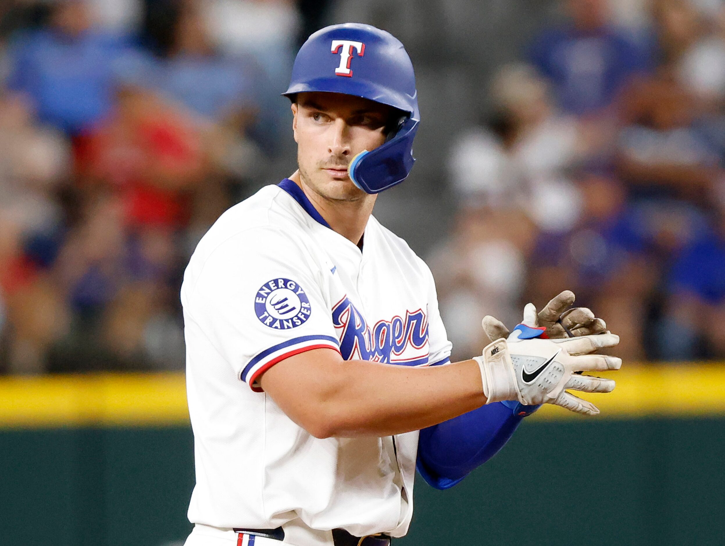 Texas Rangers designated hitter Justin Foscue applauds as he reaches second bae on a second...