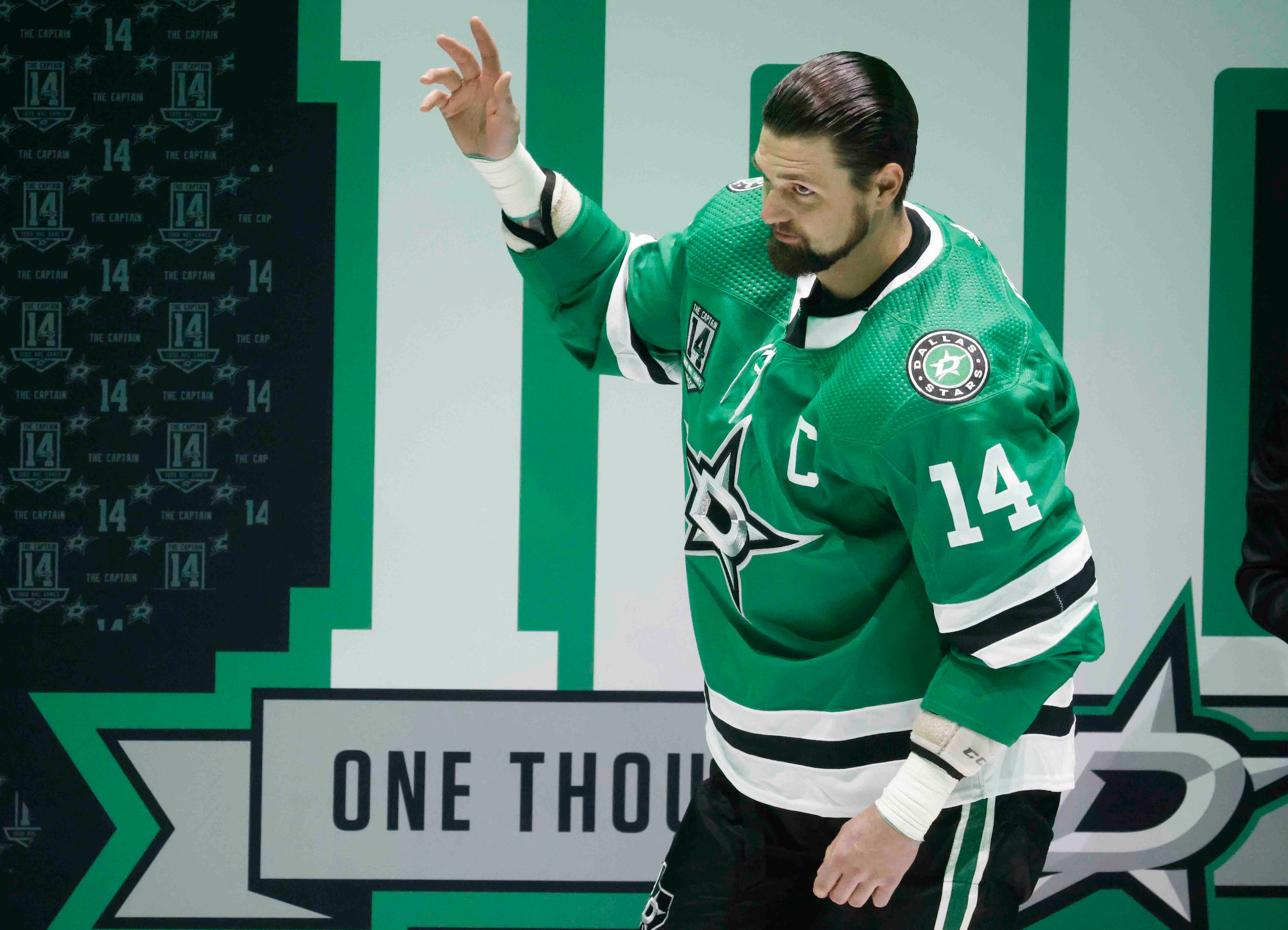 Dallas Stars left wing Jamie Benn (14)  waves during a ceremony honoring his 1000th NHL game...