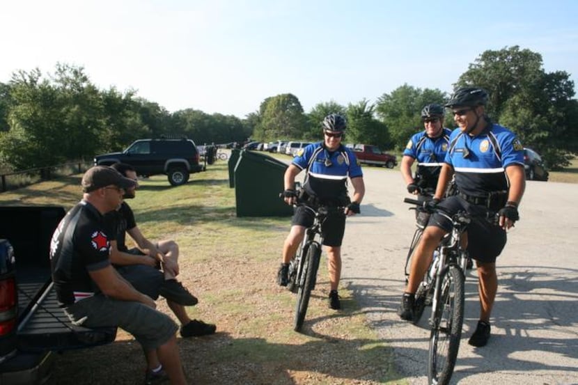 
Members of the Flower Mound police bicycle patrol stop to talk with McKinney resident Shane...