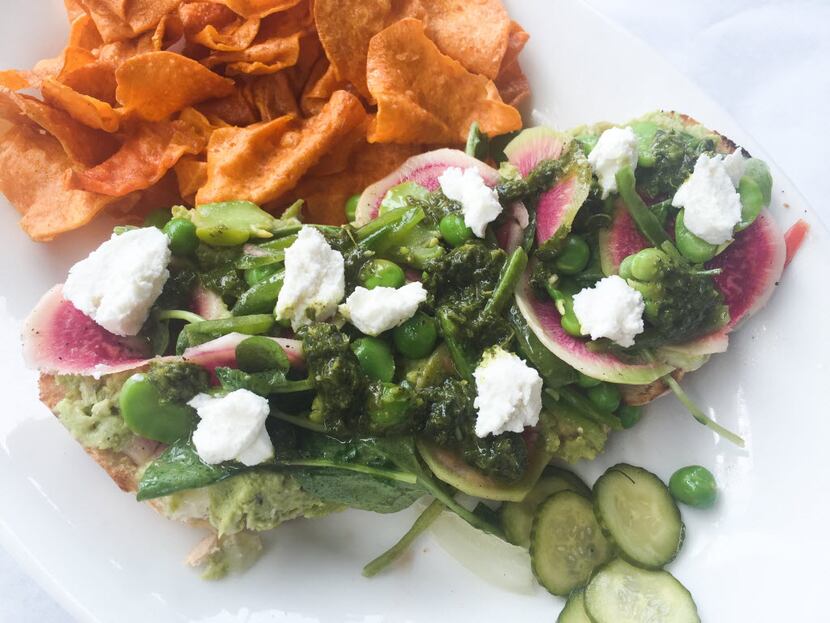 Spring vegetable toast with English pea puree, watercress, mint pistou and goat cheese at...