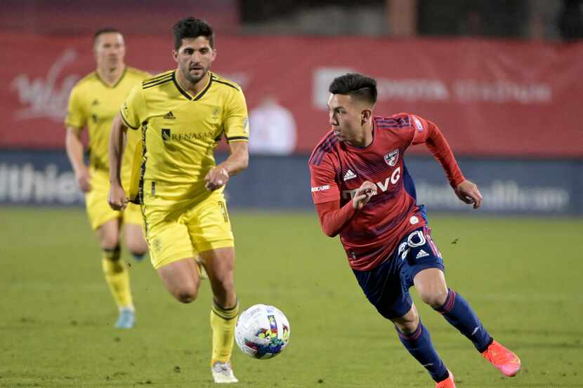 El delantero argentino del Fc Dallas, Alan Velasco (der), controla el balón en el juego...