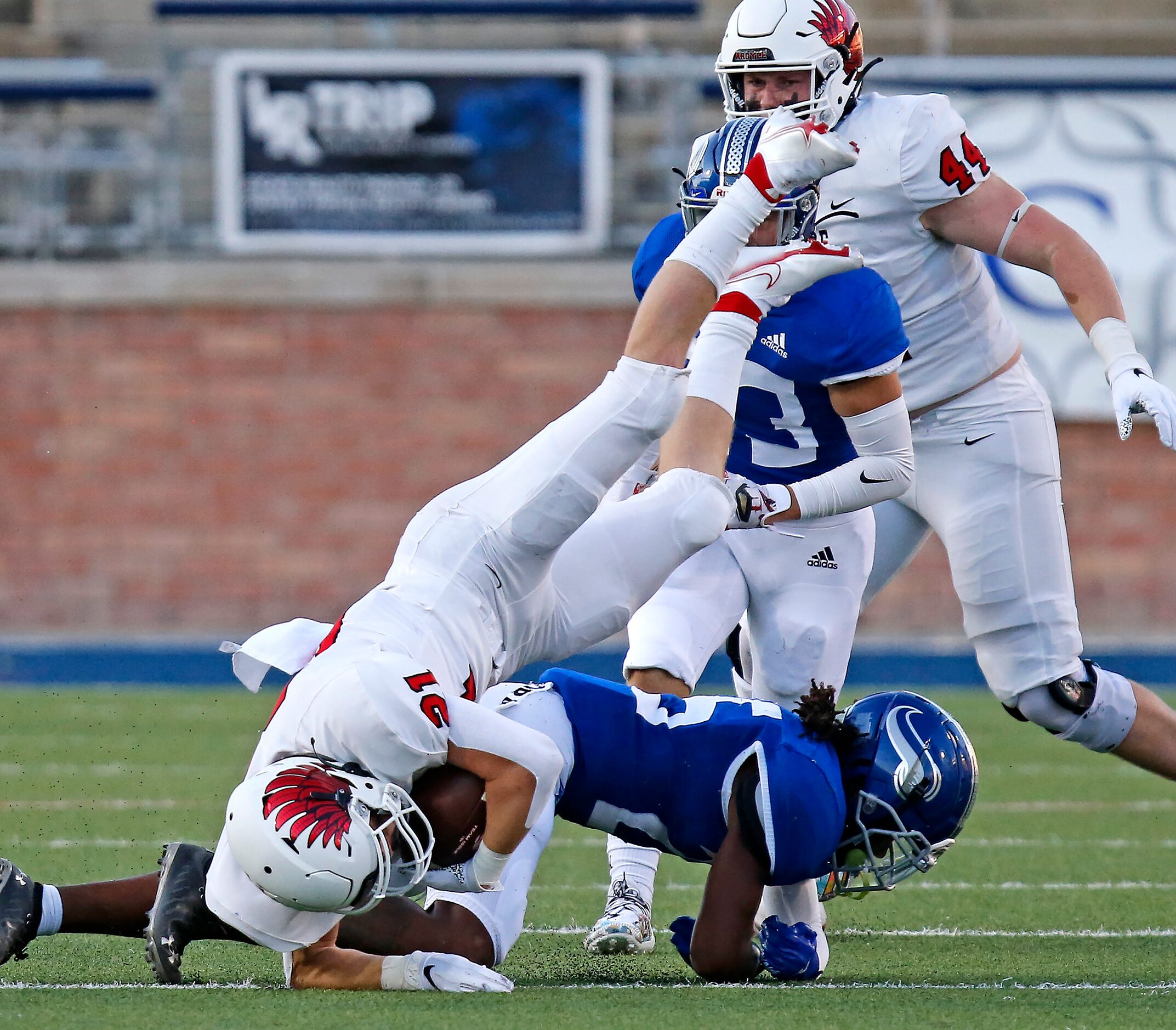 Argyle High School running back Peyton Shoemake (21) is upended by Nolan Catholic High...