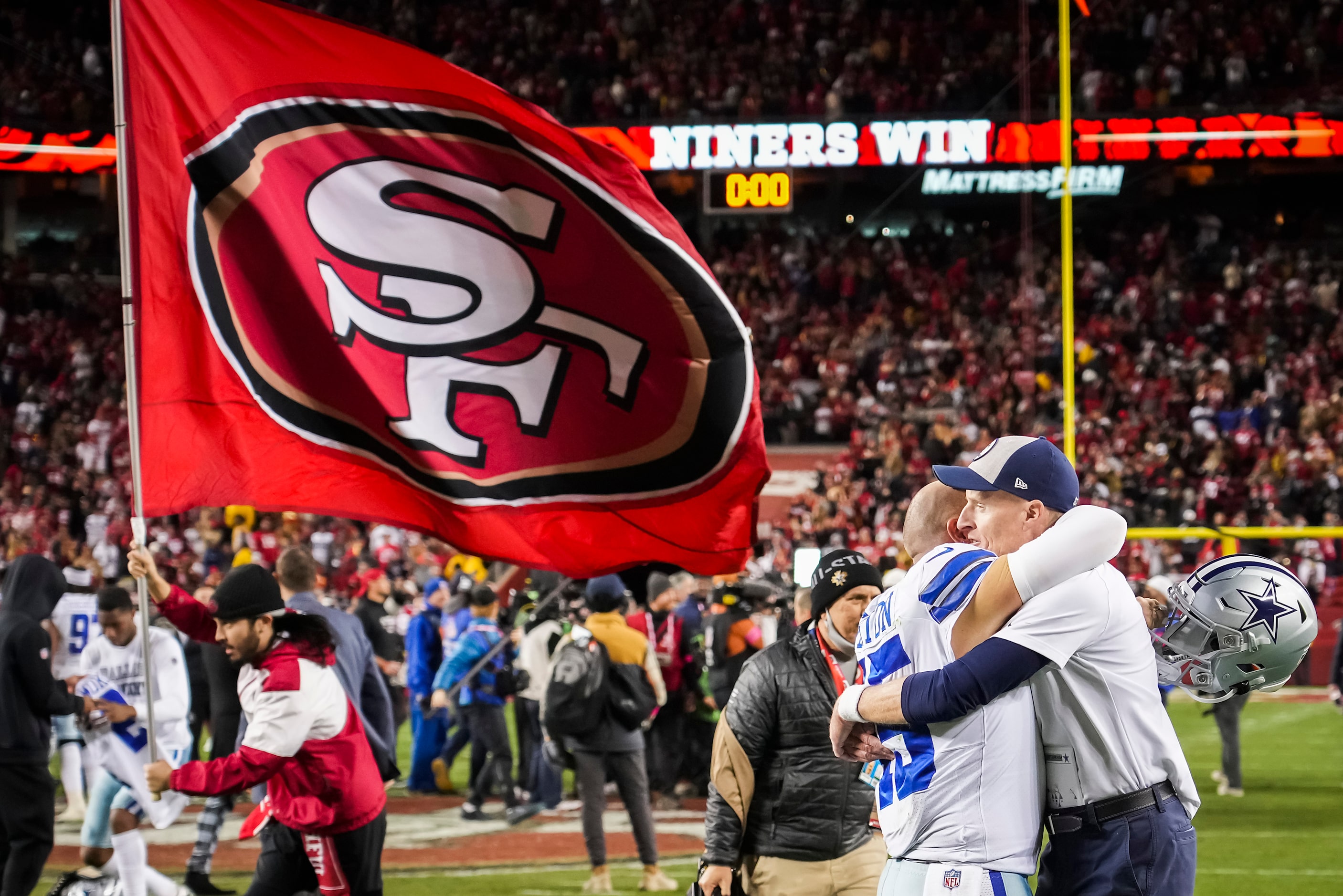 Dallas Cowboys special teams coordinator John Fassel hugs long snapper Matt Overton (45)...