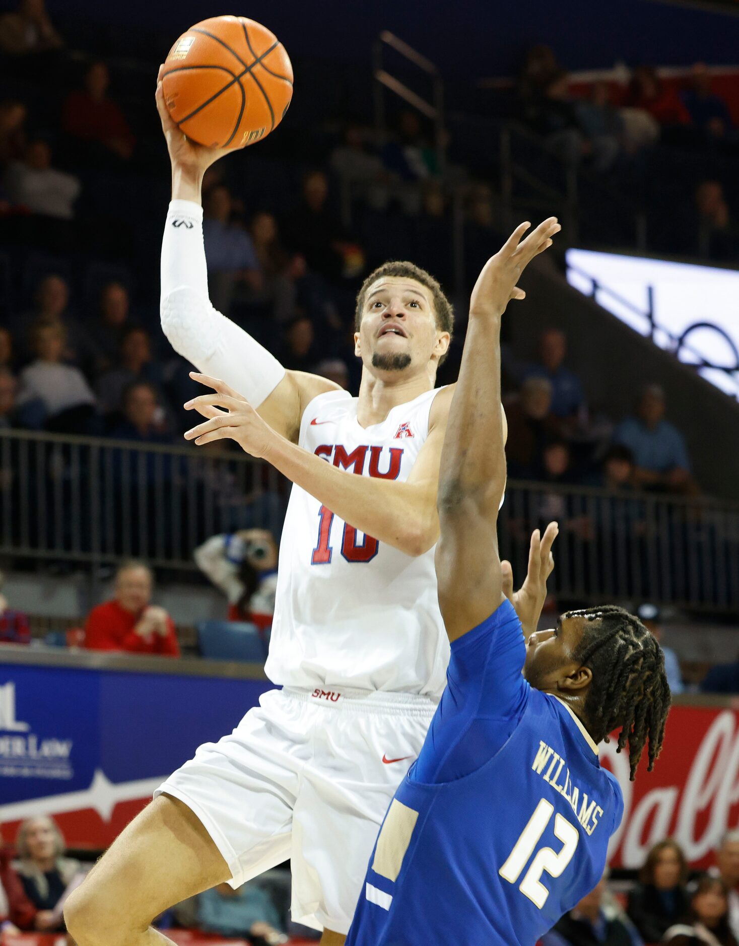 Southern Methodist forward Samuell Williamson (left) drives to the basket over Tulsa forward...