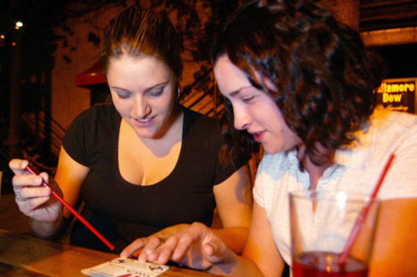 ORG XMIT: *S0401474227* Sara Lively, 24, left and Michelle Coler, 21, test their drinks for...