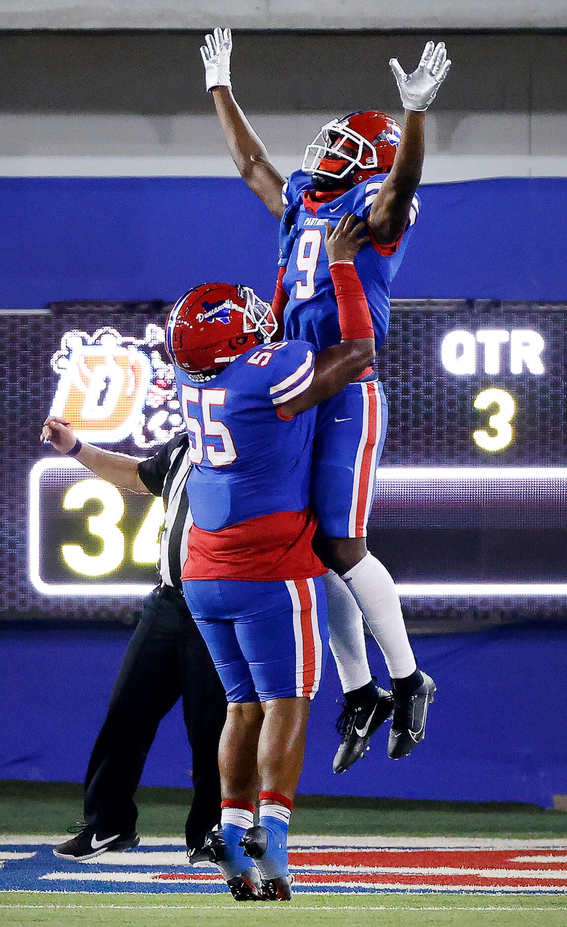 Duncanville’s Zach Turner (9) is hoisted in the air by teammate Damian Martinez (55) after...