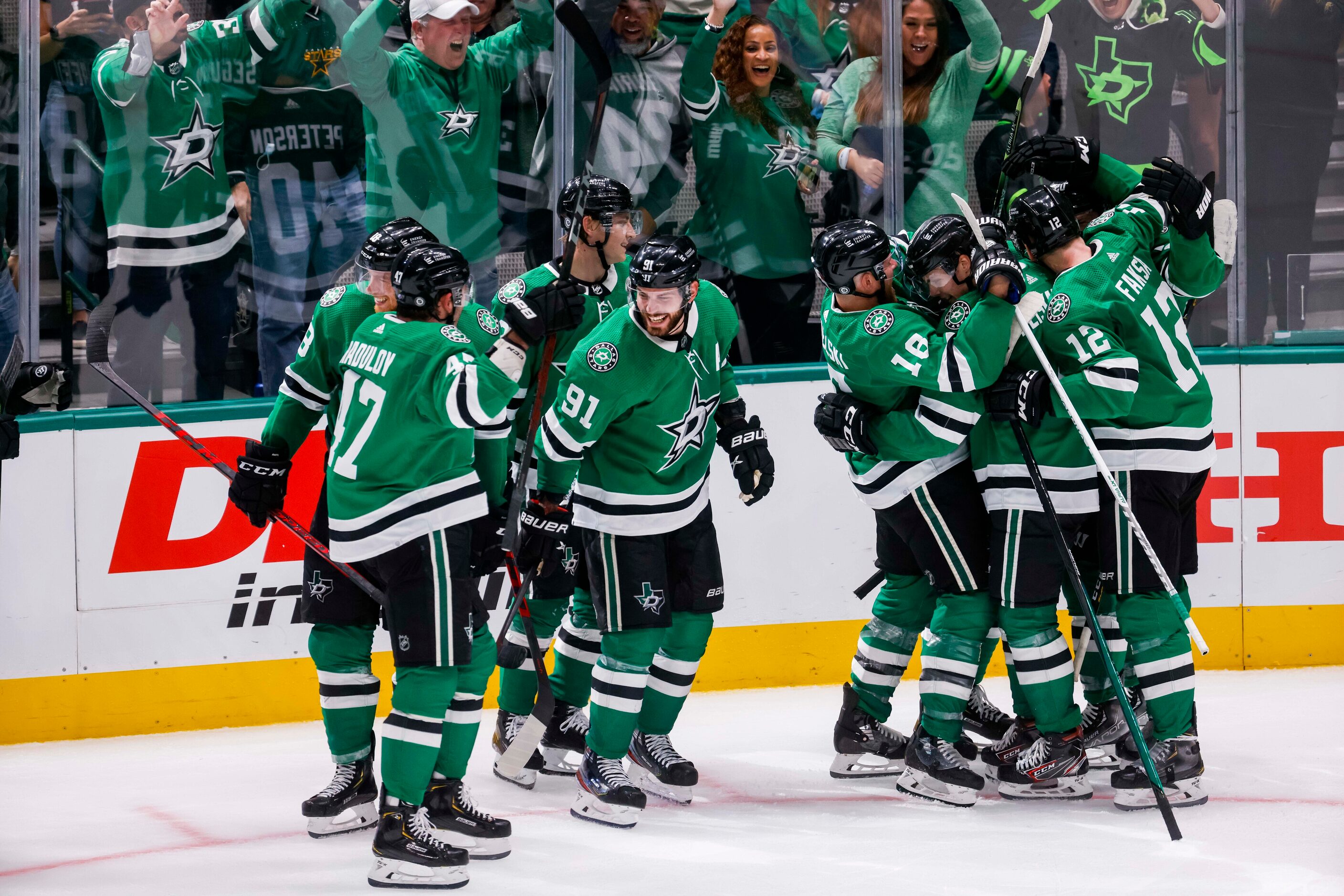 Dallas Stars right wing Denis Gurianov (34) teammates after hitting the game winning puck...