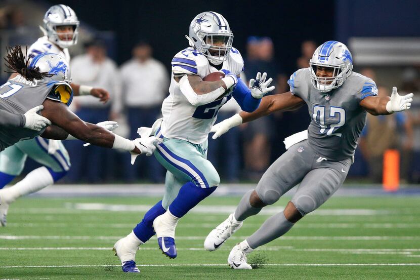 Dallas Cowboys running back Ezekiel Elliott (21) breaks away from Detroit Lions linebacker...