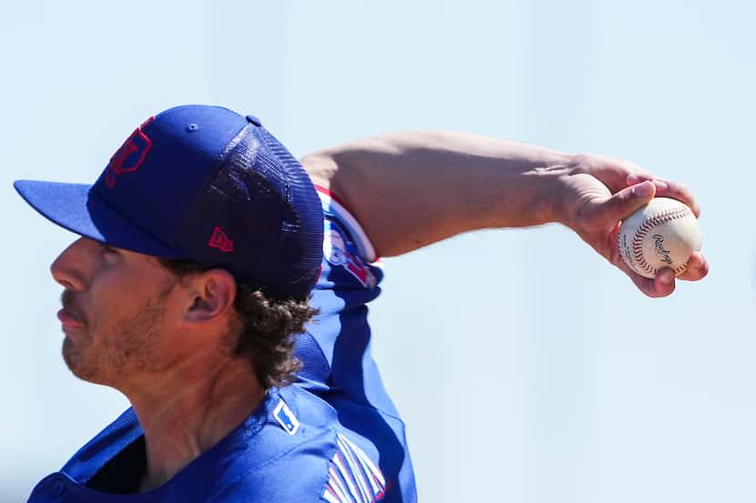 Texas Rangers pitcher Cole Winn throws in the bullpen during a spring training workout at...