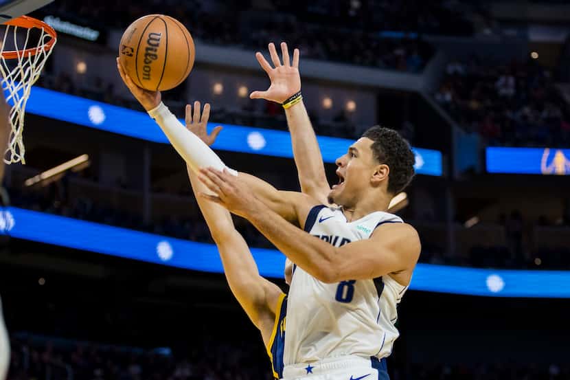 Dallas Mavericks guard Josh Green lays up the ball against the Golden State Warriors during...
