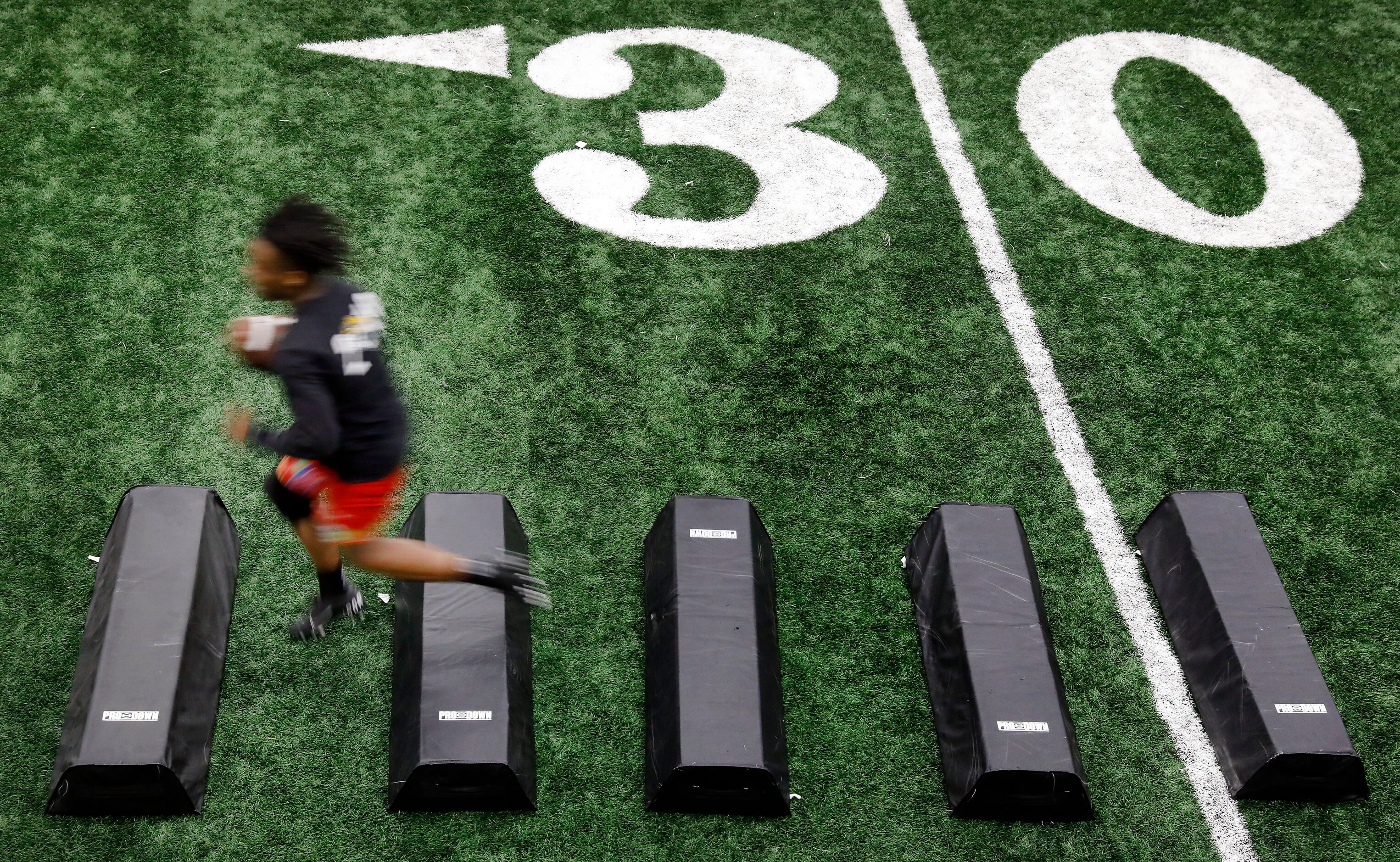 Unsigned senior running back Glen Jackson of Molina High School shows his footwork before...