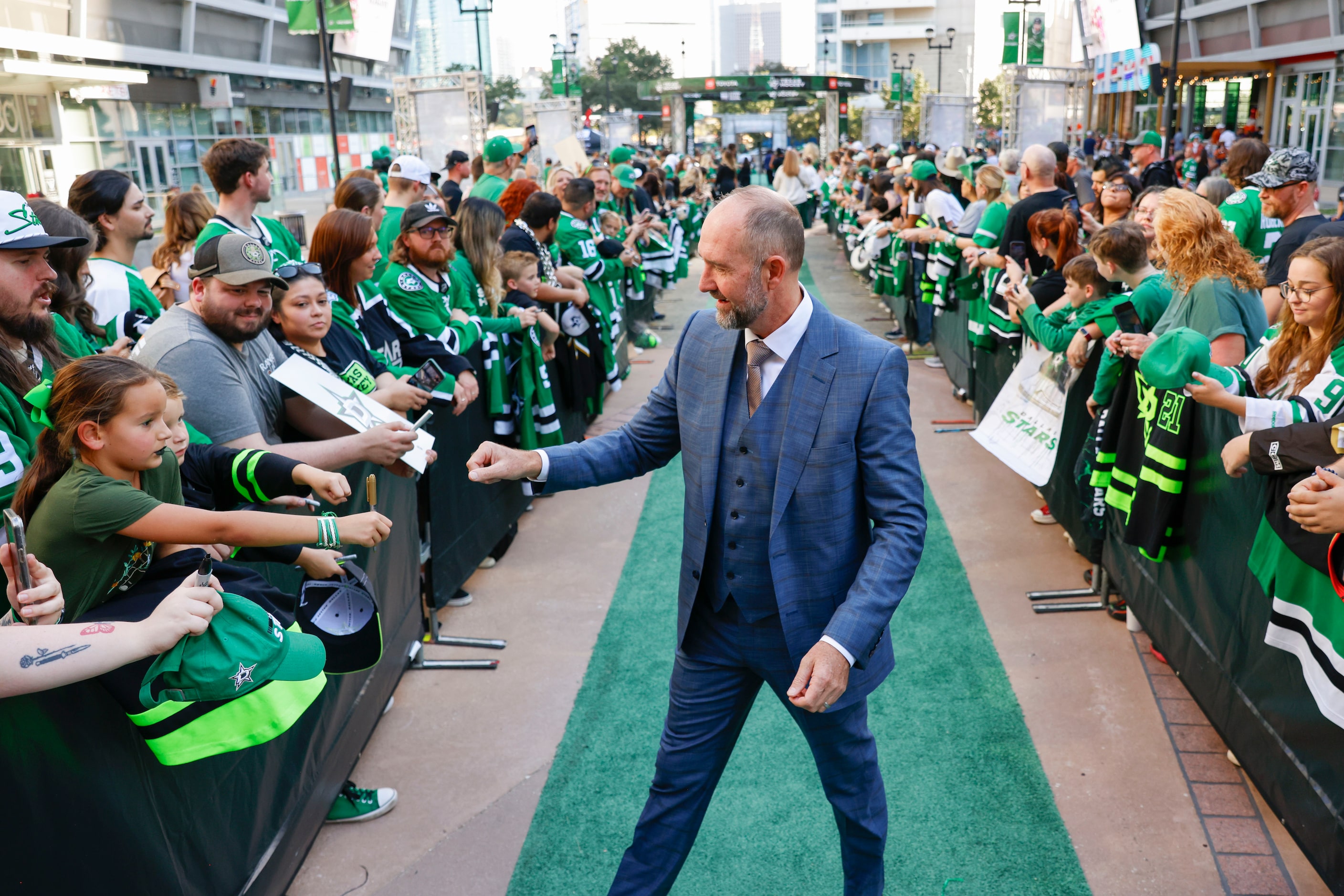 Dallas Stars head coach Peter DeBoer interacts with the crowd during the team’s home opener...