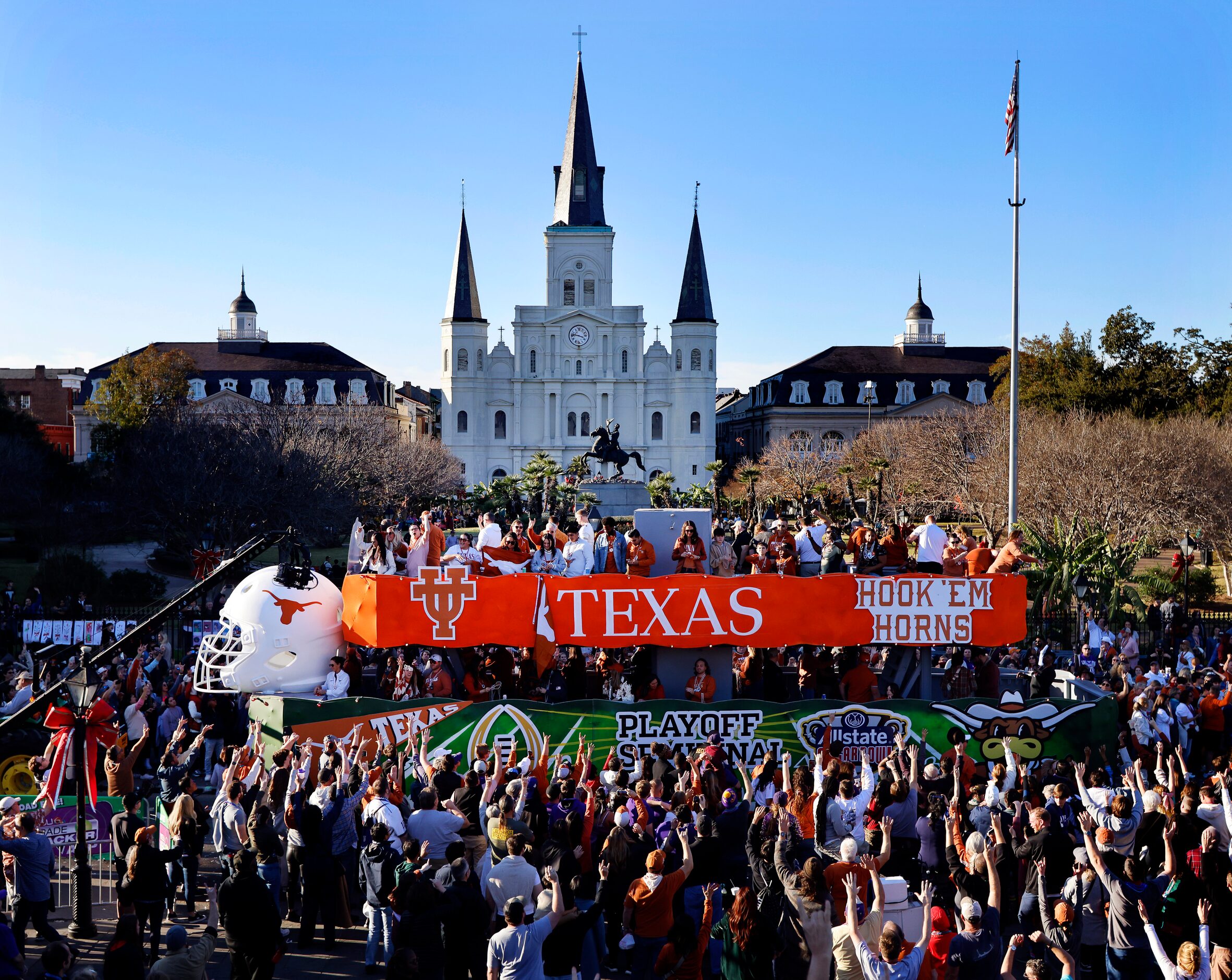 Texas Longhorns fans throw beads from atop a large float during the Mardi Gras-style...