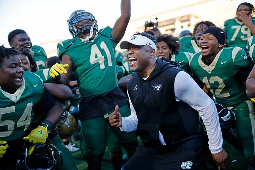 DeSoto head coach Claude Mathis (center) celebrates with his players after a 45-38 victory...