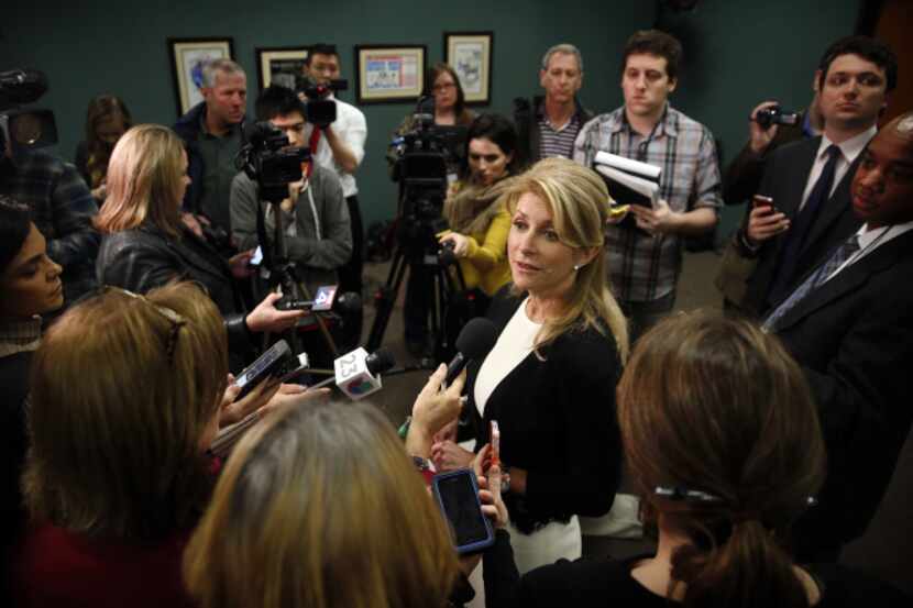 State Sen. Wendy Davis took questions from the media after unveiling her first piece of...