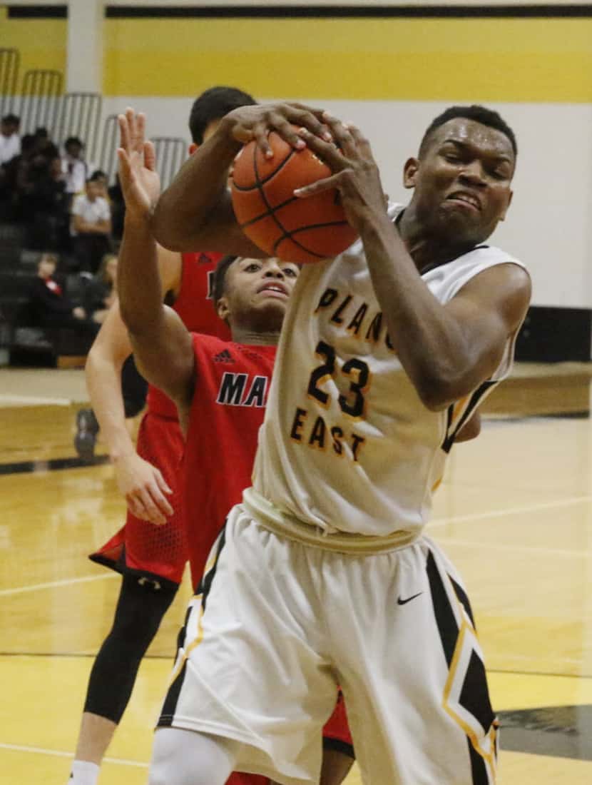 Plano East Devin Gifford, #23, grabs a rebound against  Flower Mound Marcus in District 6-6A...