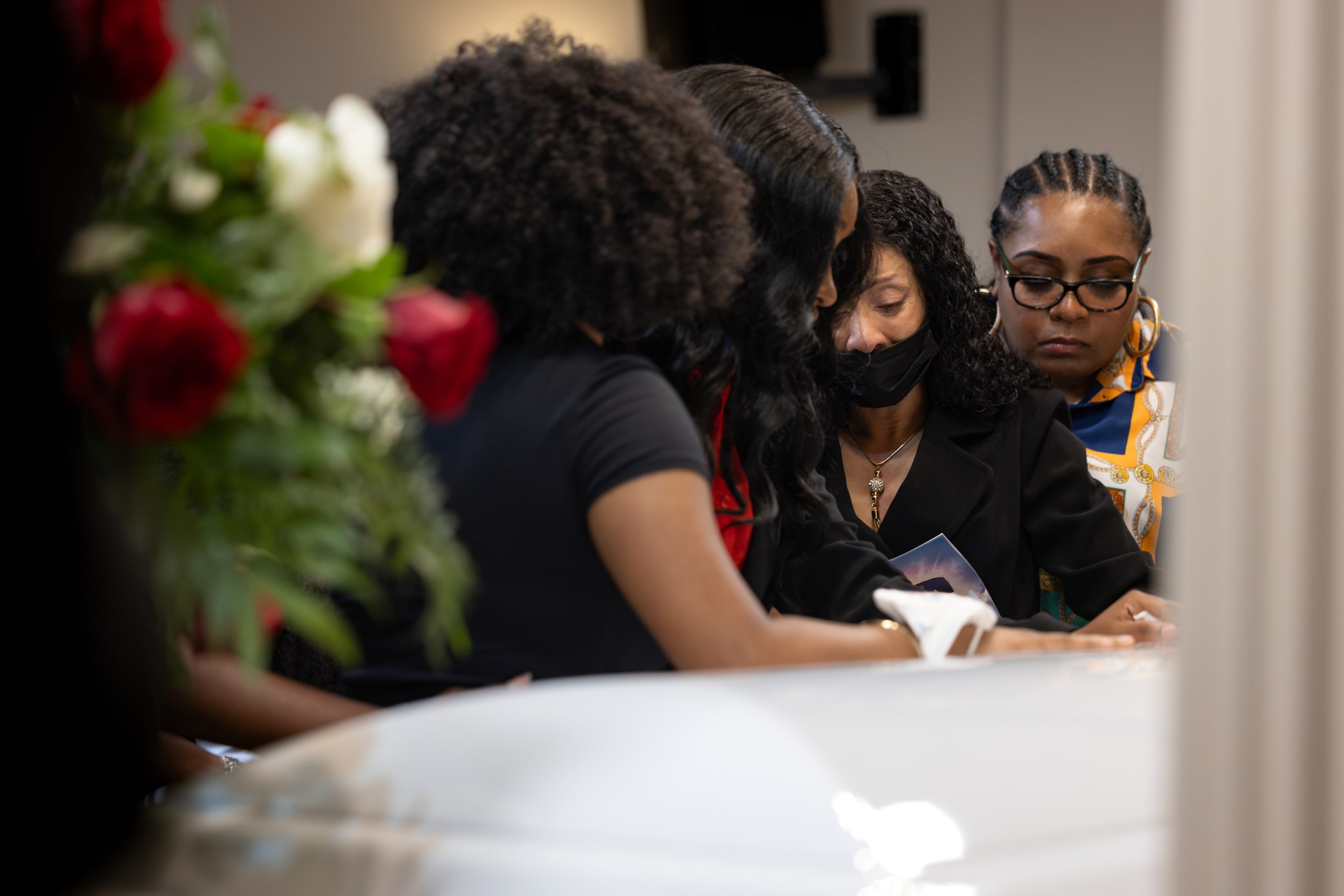 De'Maryae Daquan Hill-Young's mother, Destinae Hill lifts closes his casket during a funeral...