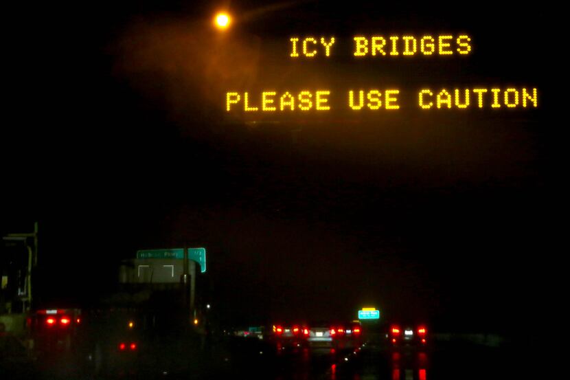 A sign warns of icy bridges on Texas State Highway 121  on December 5, 2013 in Carrollton....