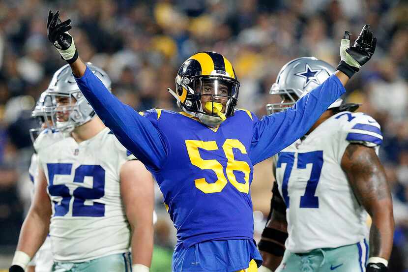 Los Angeles Rams linebacker Dante Fowler (56) plays to the crowd as they wait for a fourth...