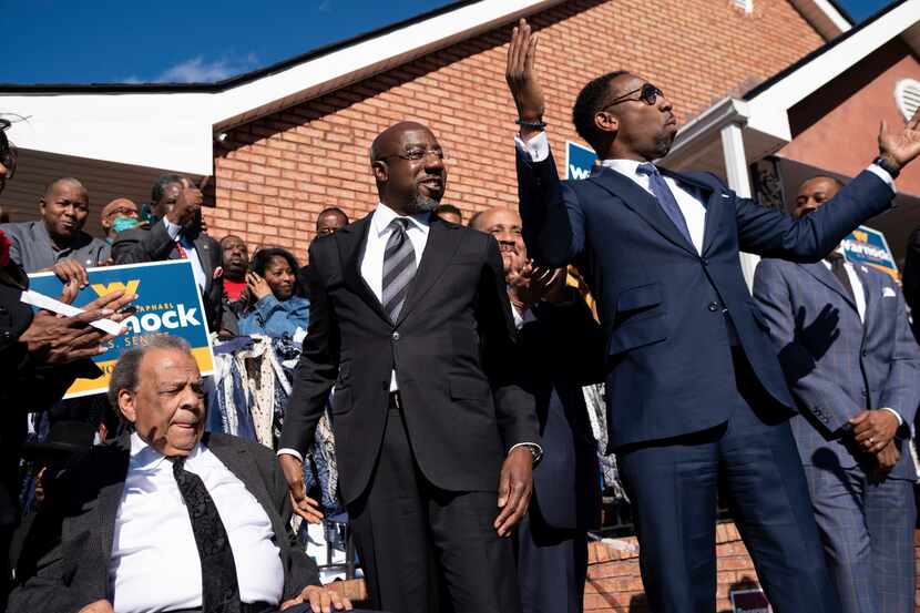 FILE - Sen. Raphael Warnock, D-Ga., center, prepares to speak at a rally after being...