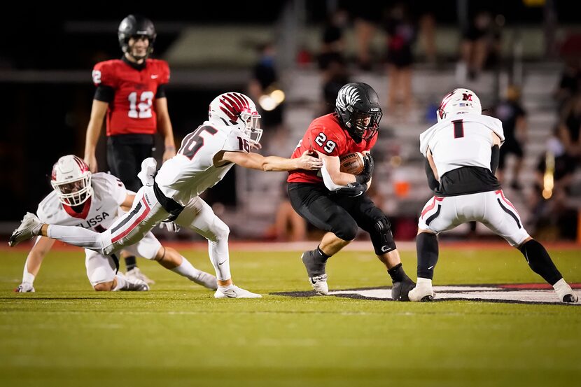 Argyle running back Braden Baker (29) tries to slip through Melissa defensive backs Dylan...