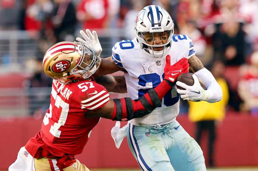 Dallas Cowboys running back Tony Pollard (20) pushes off San Francisco 49ers linebacker Dre...