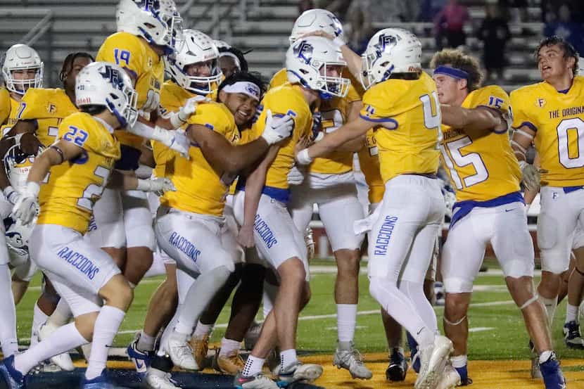 Frisco High School kicker Mason Stallons (6) (center) gets mobbed by his team mates after...