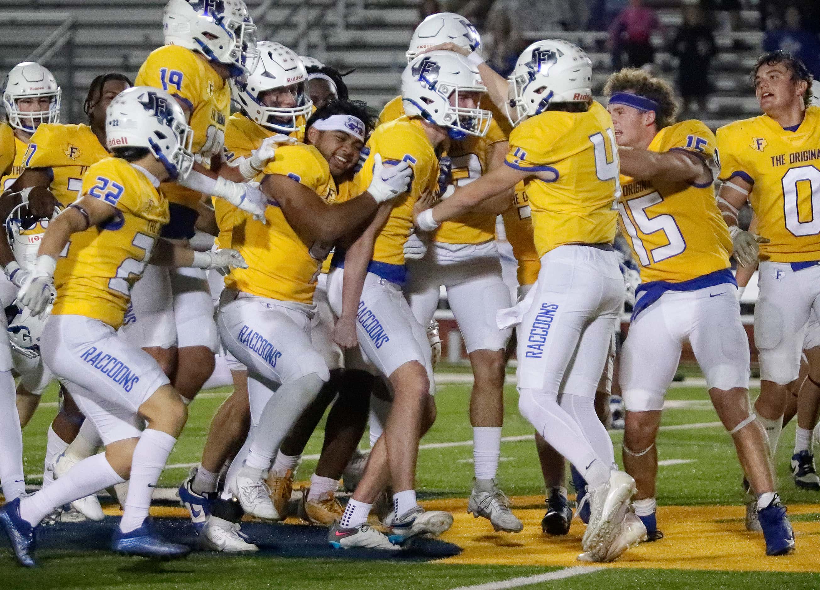 Frisco High School kicker Mason Stallons (6) (center) gets mobbed by his team mates after...