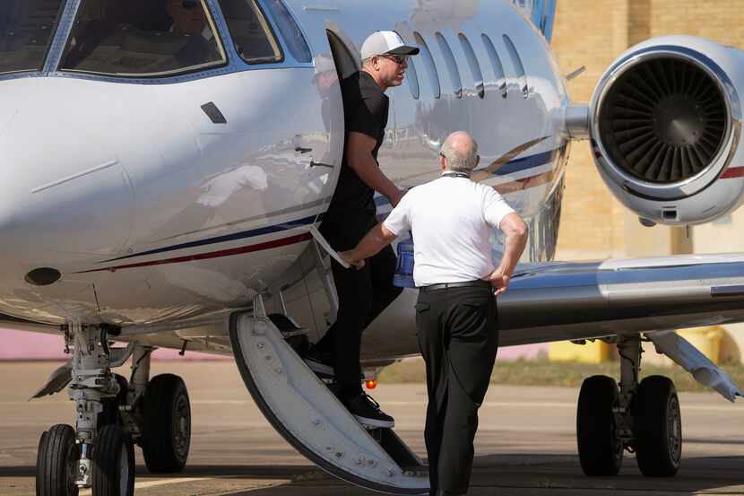 Troy Aikman steps off his private plane after arriving on Friday in Okmulgee, Okla. Aikman,...