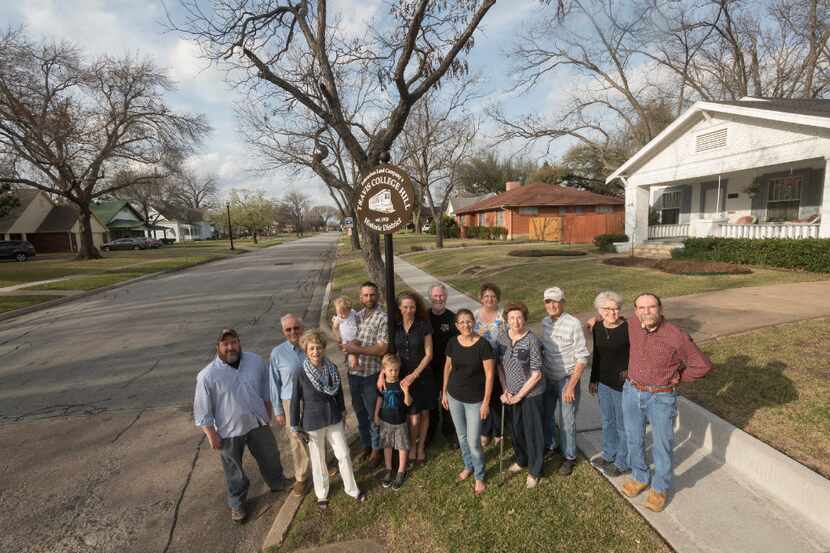 Residents who live in Garland's Travis College Hill District gather on the corner on Monday,...