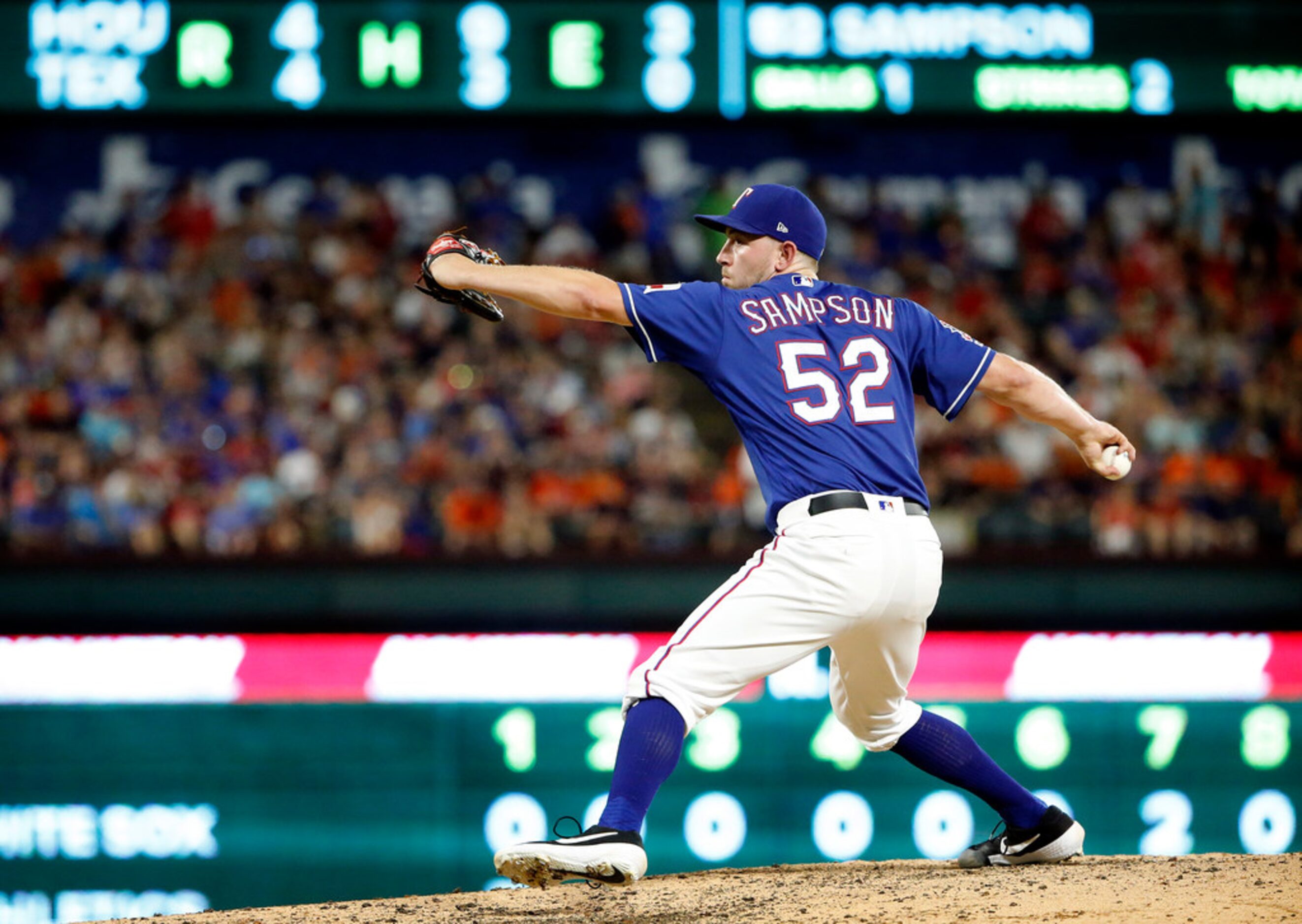 Texas Rangers starting pitcher Adrian Sampson (52) throws against the Houston Astros in the...