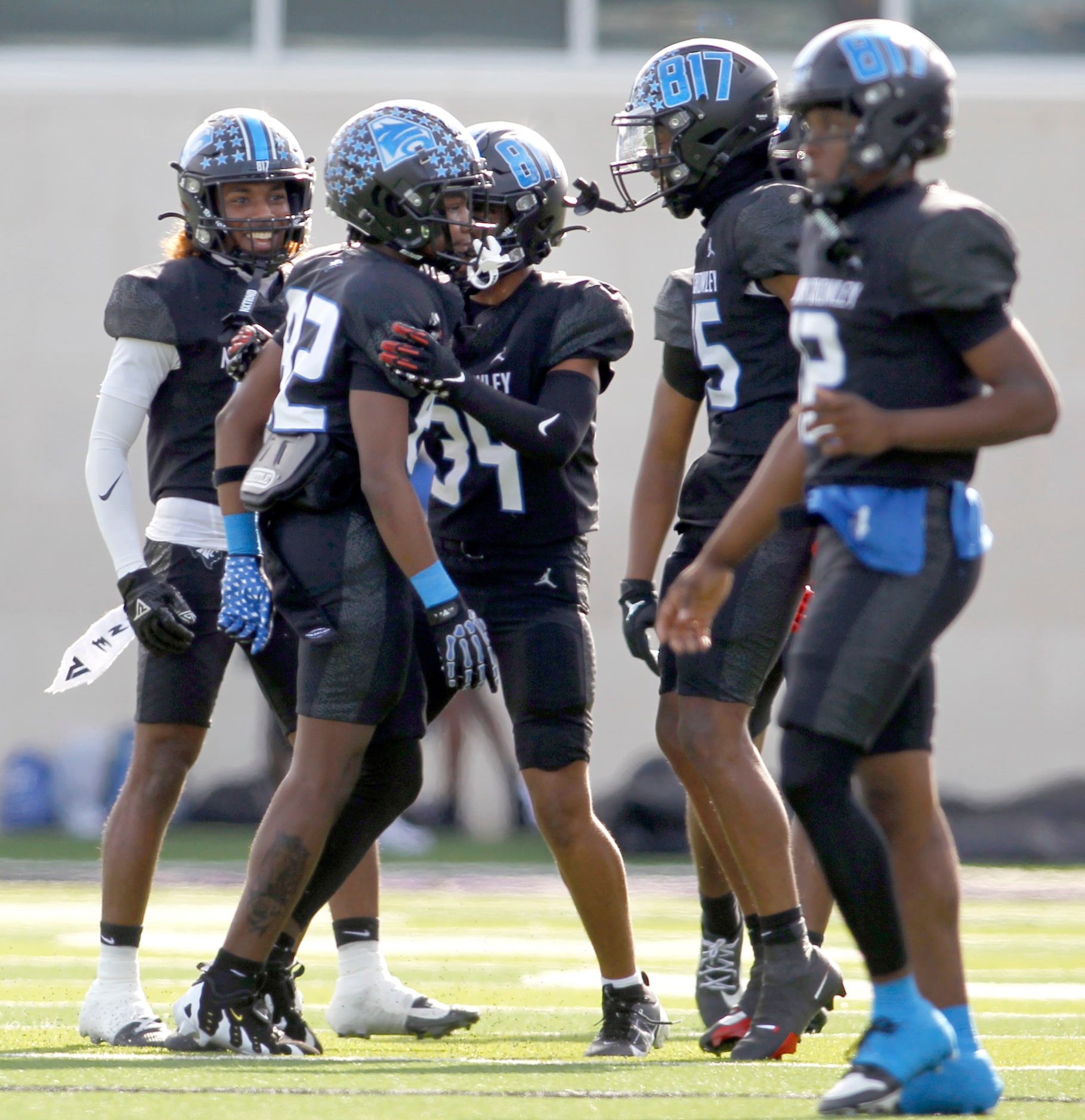 North Crowley punter Malachi Releford (82), 2nd from left, receives congratulations after...