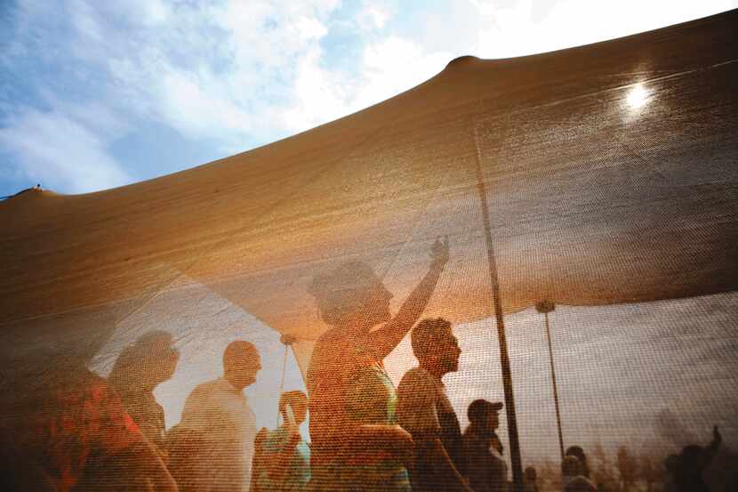 Members of First Baptist Church of Rockport sing during their Sunday service, held in a tent...