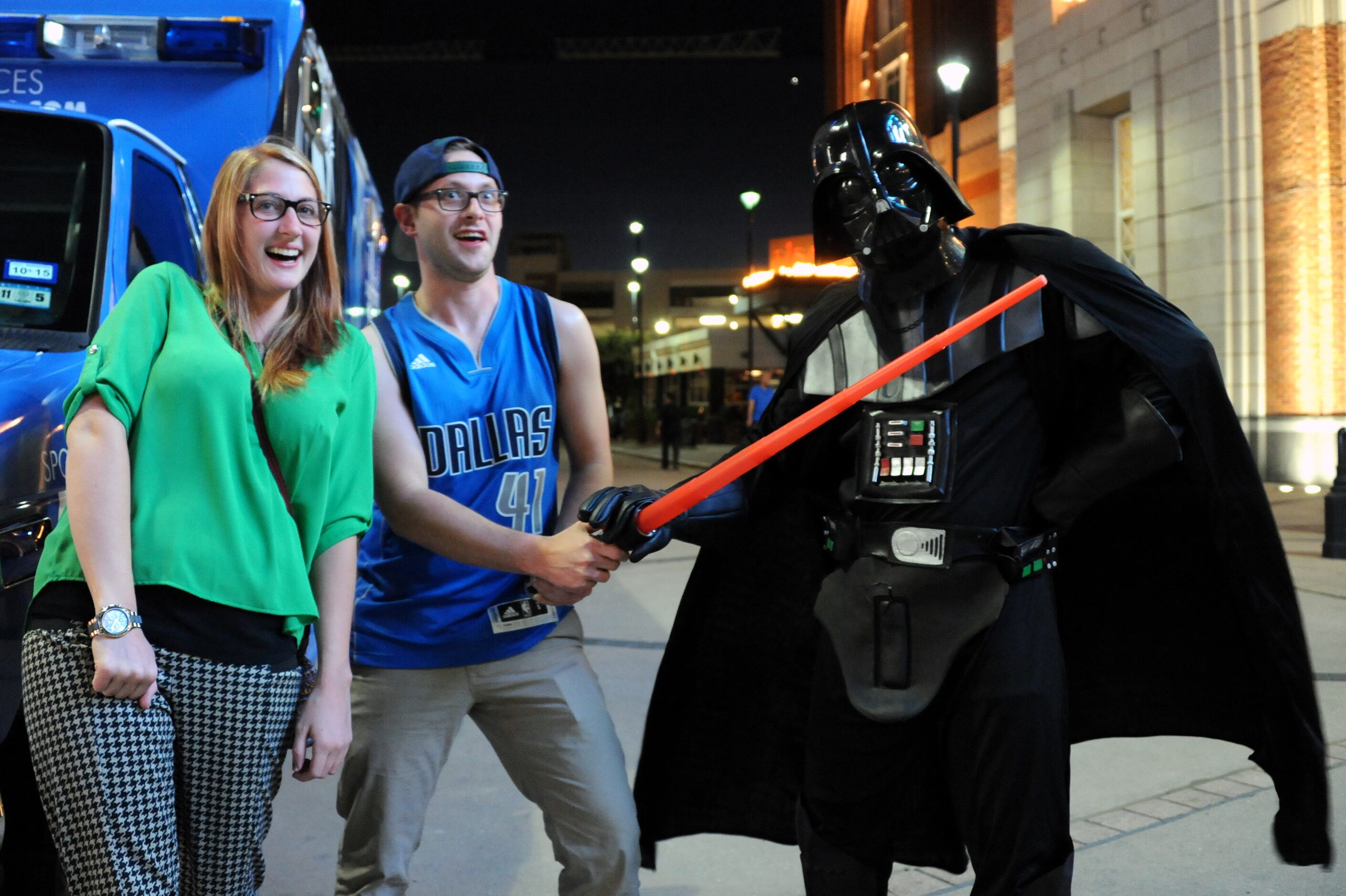 Rebecca and Taylor Avery fight Darth Vader at Star Wars night at the Dallas Mavericks...