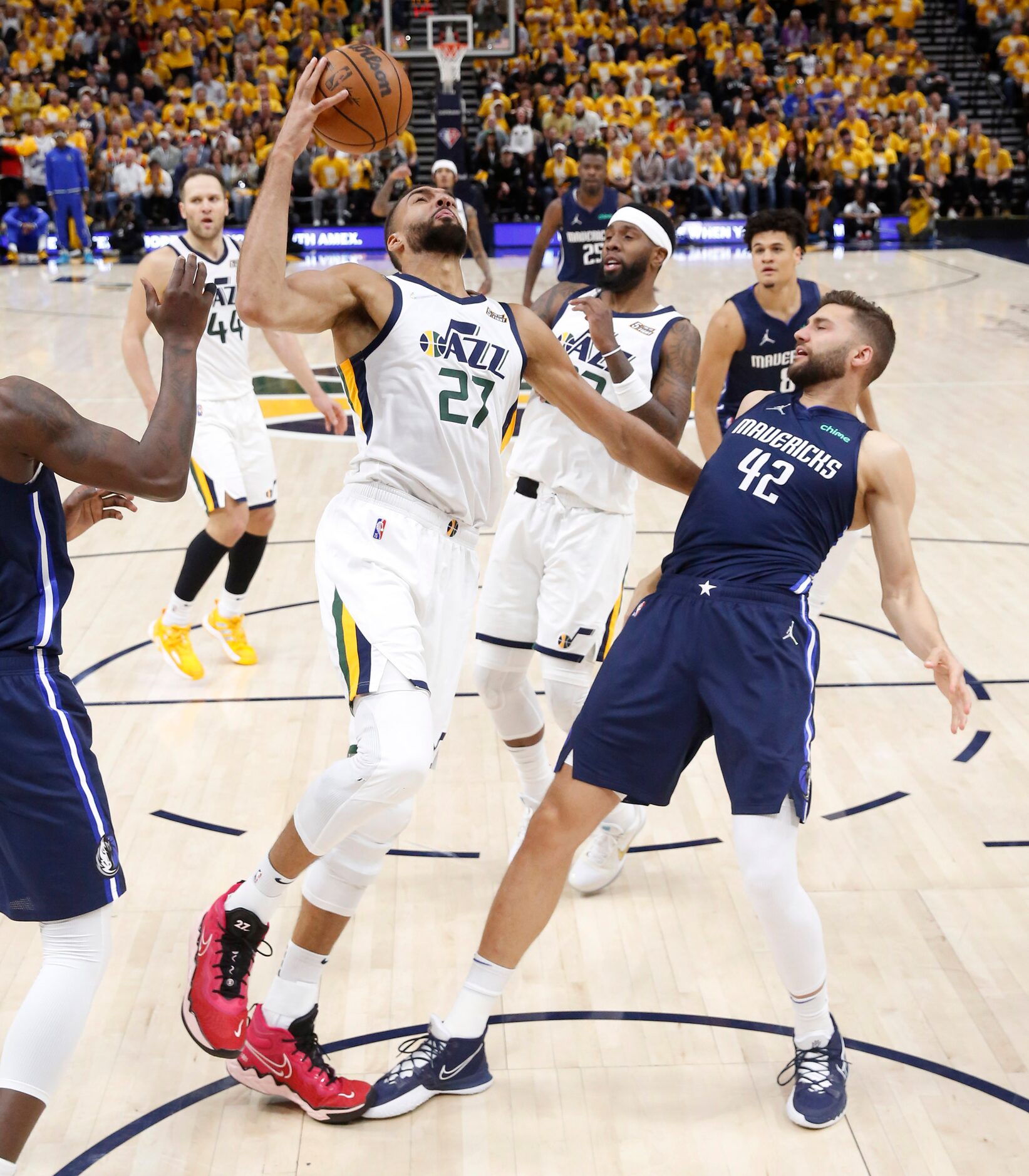 Utah Jazz center Rudy Gobert (27) pulls on the jersey of Dallas Mavericks forward Maxi...