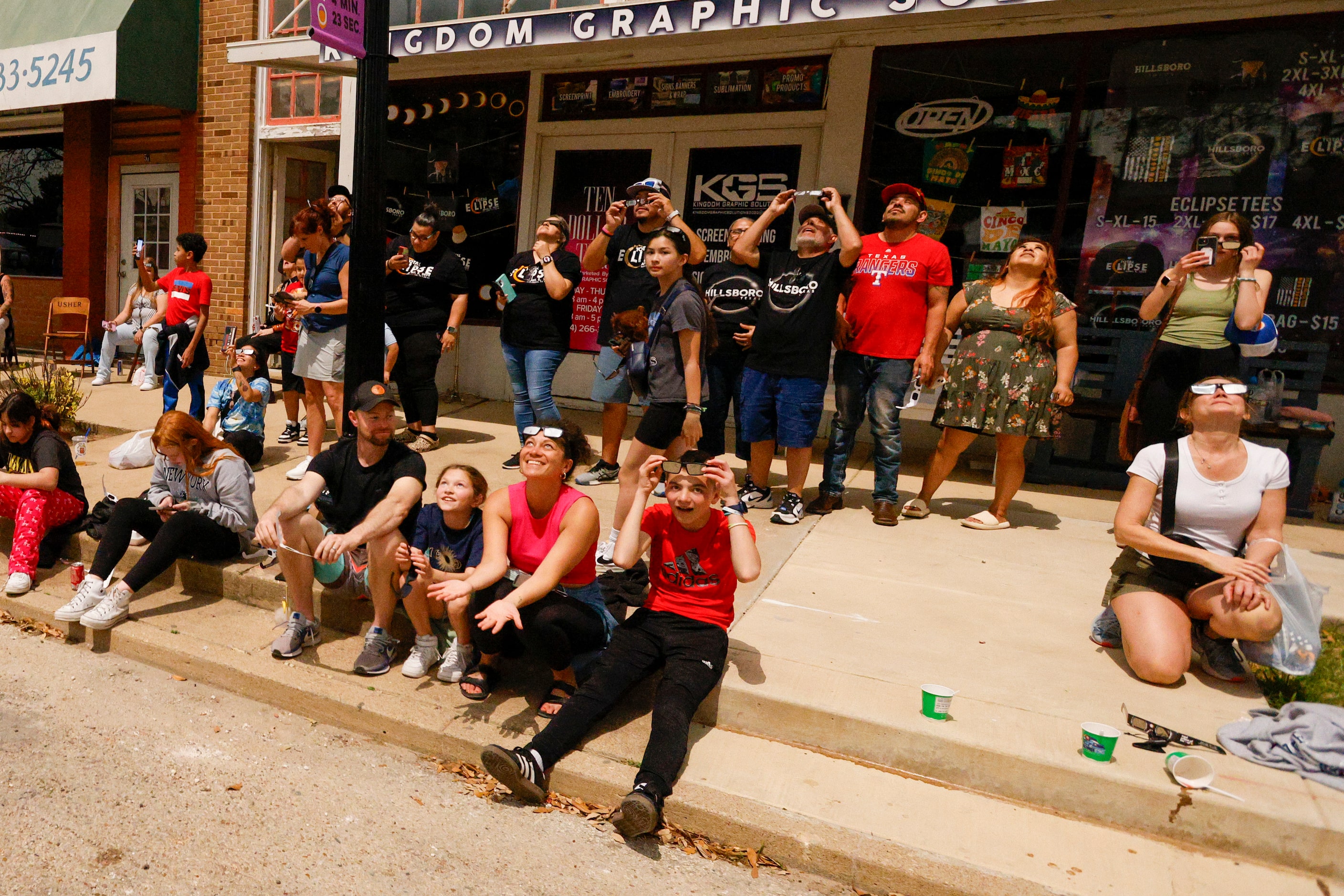 People look to the sky moments after a total solar eclipse, Monday, April 8, 2024, in...