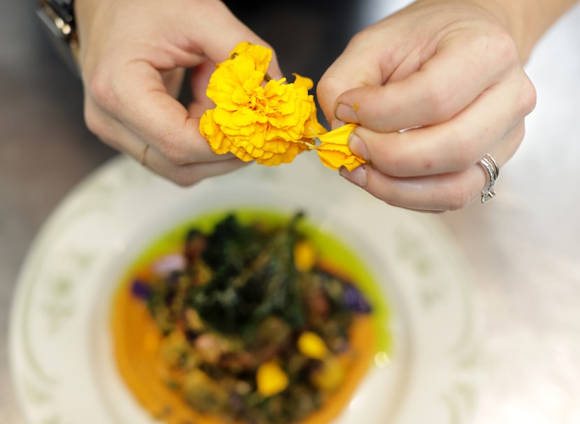 Executive chef Andrea Shackelford adds the final touches to a dish at the newly Michelin...