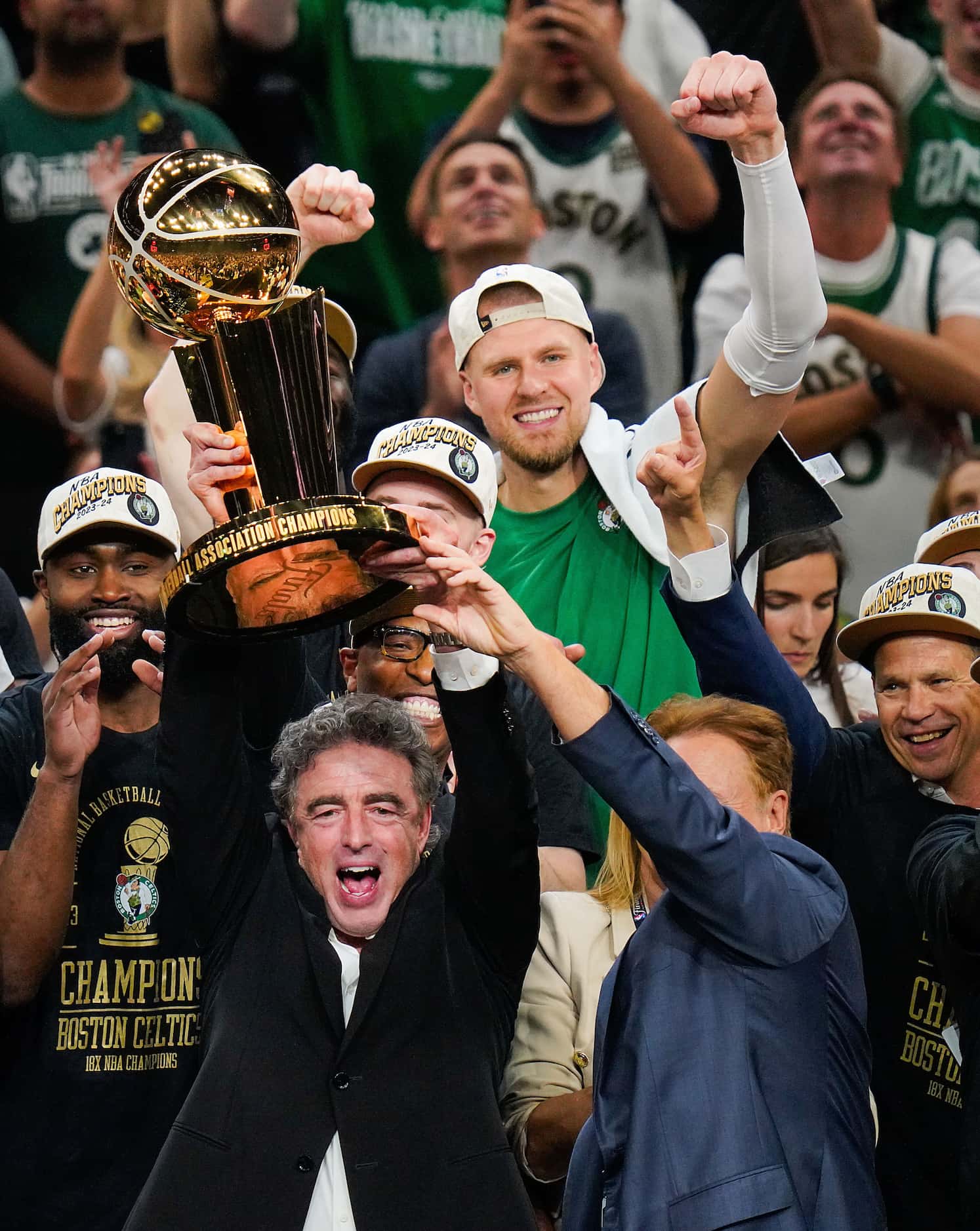 Boston Celtics owner Wyc Grousbeck lifts the Larry O'Brien Championship Trophy after a...