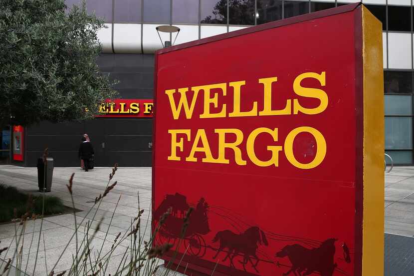 A sign is posted in front of a Wells Fargo bank on October 11, 2013 in Oakland, California....