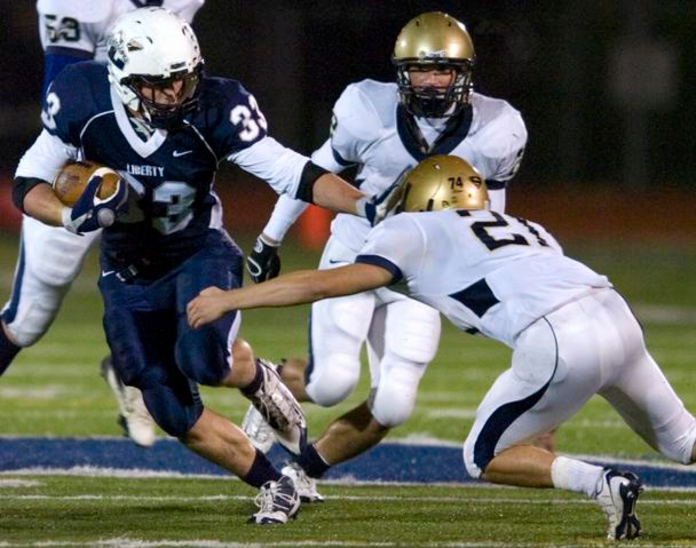 Argyle Liberty Christian senior running back Reid Fitzgerald (33) stiff-arms Arlington Grace...