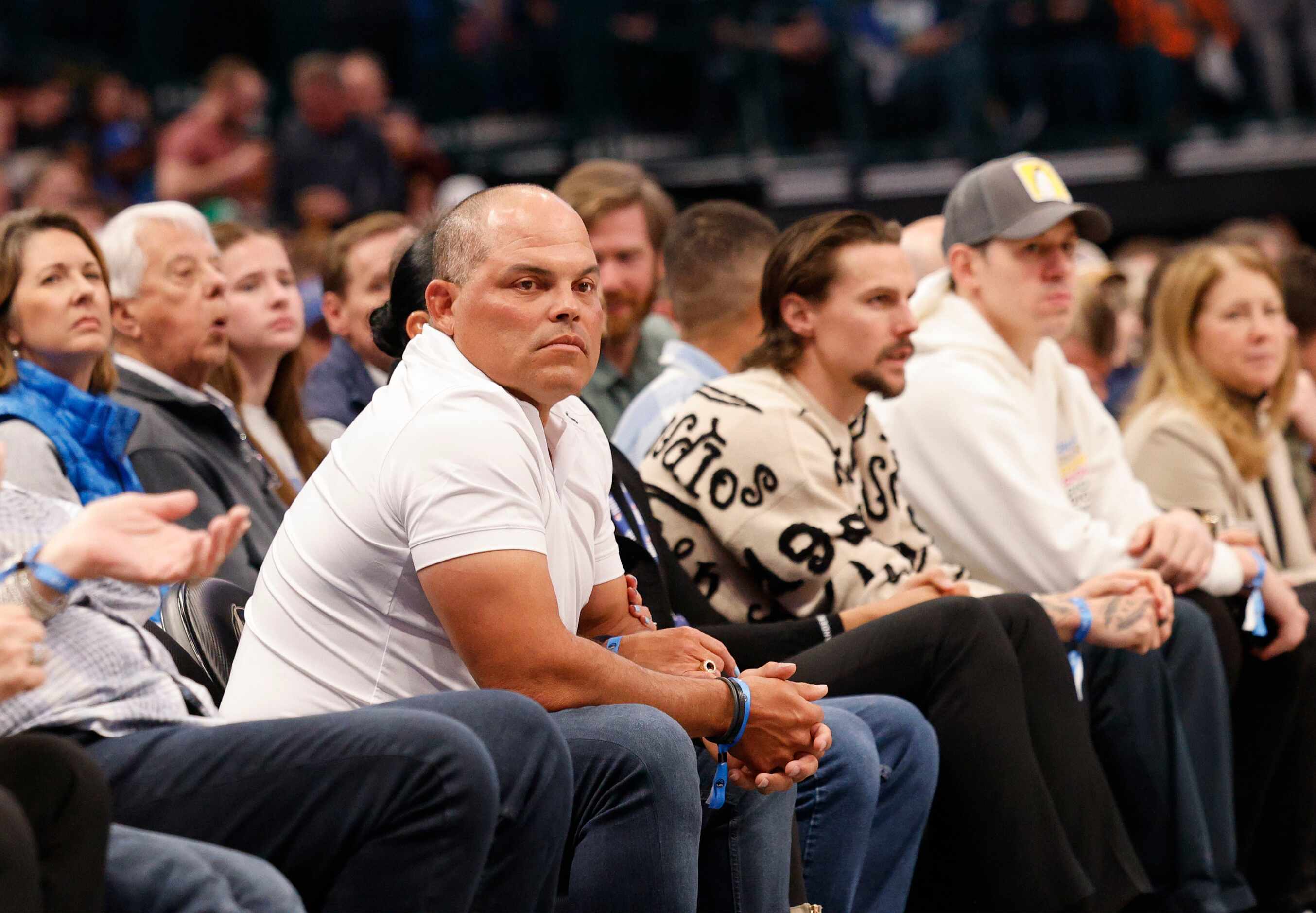 Former Texas Rangers player  Iván “Pudge” Rodríguez, left, watches an NBA basketball game...