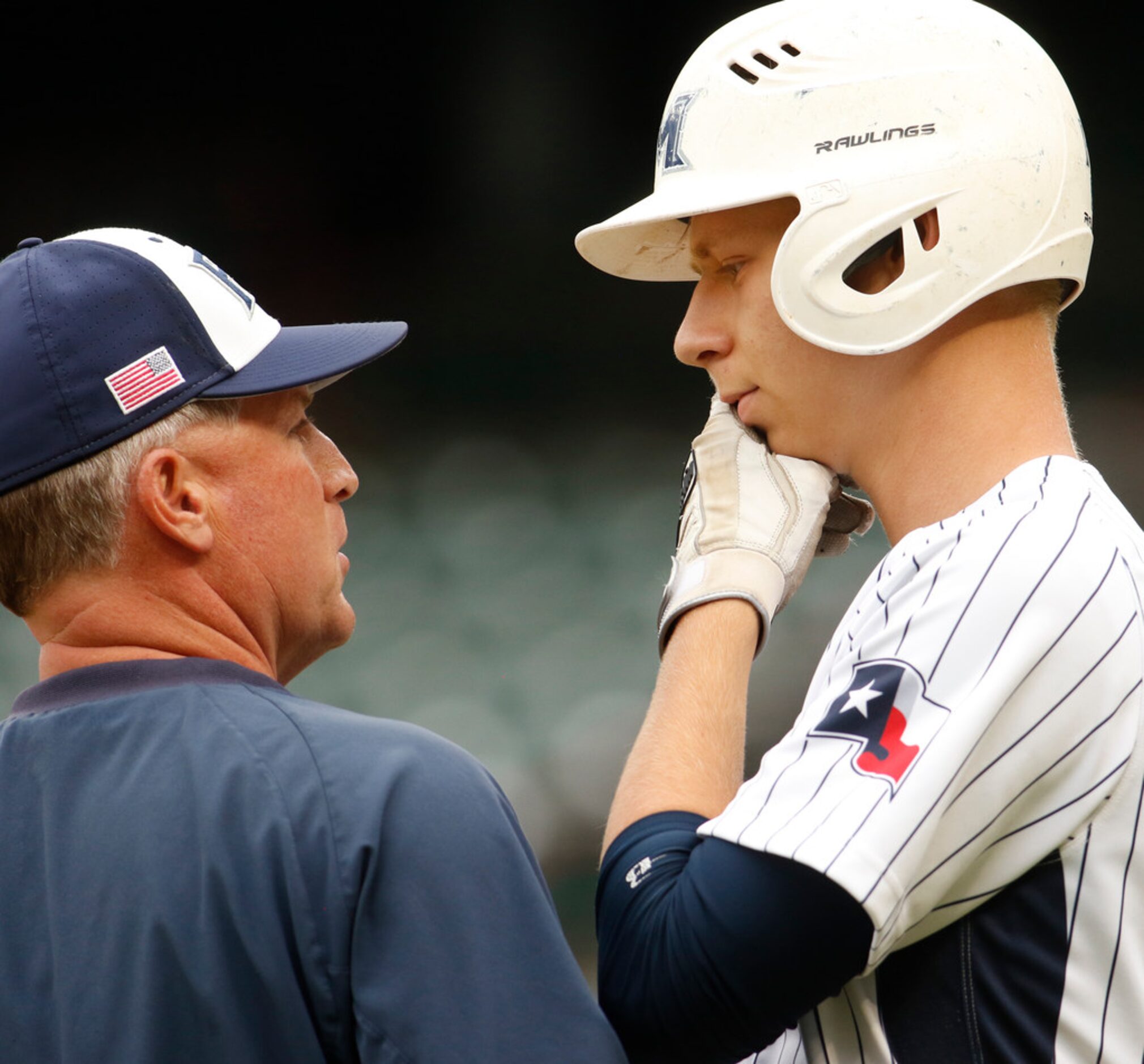 Flower Mound designated hitter Geoff Marlow (9) listens intently to the advice of Jaguars...