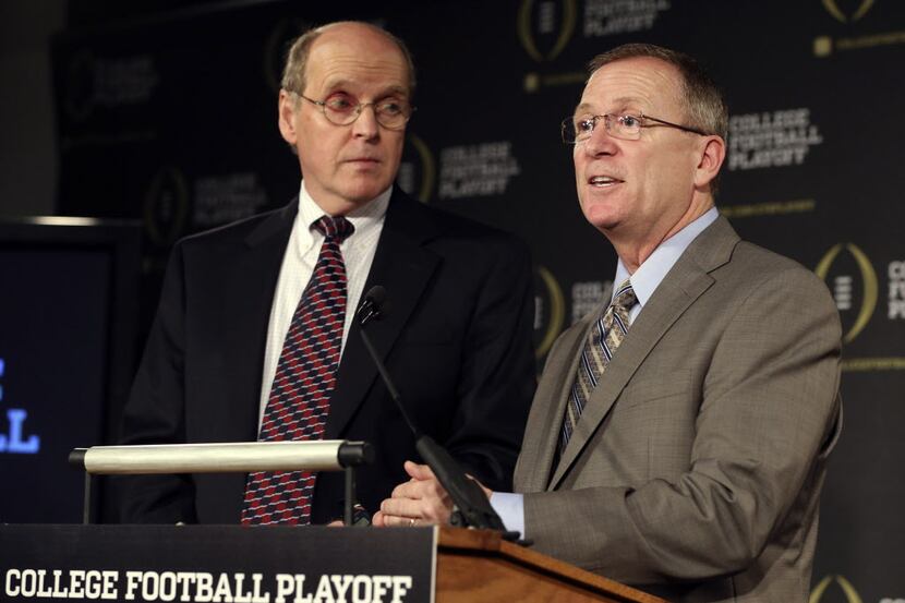 College Football Executive Director Bill Hancock (left) and Jeff Long, Chairman of College...