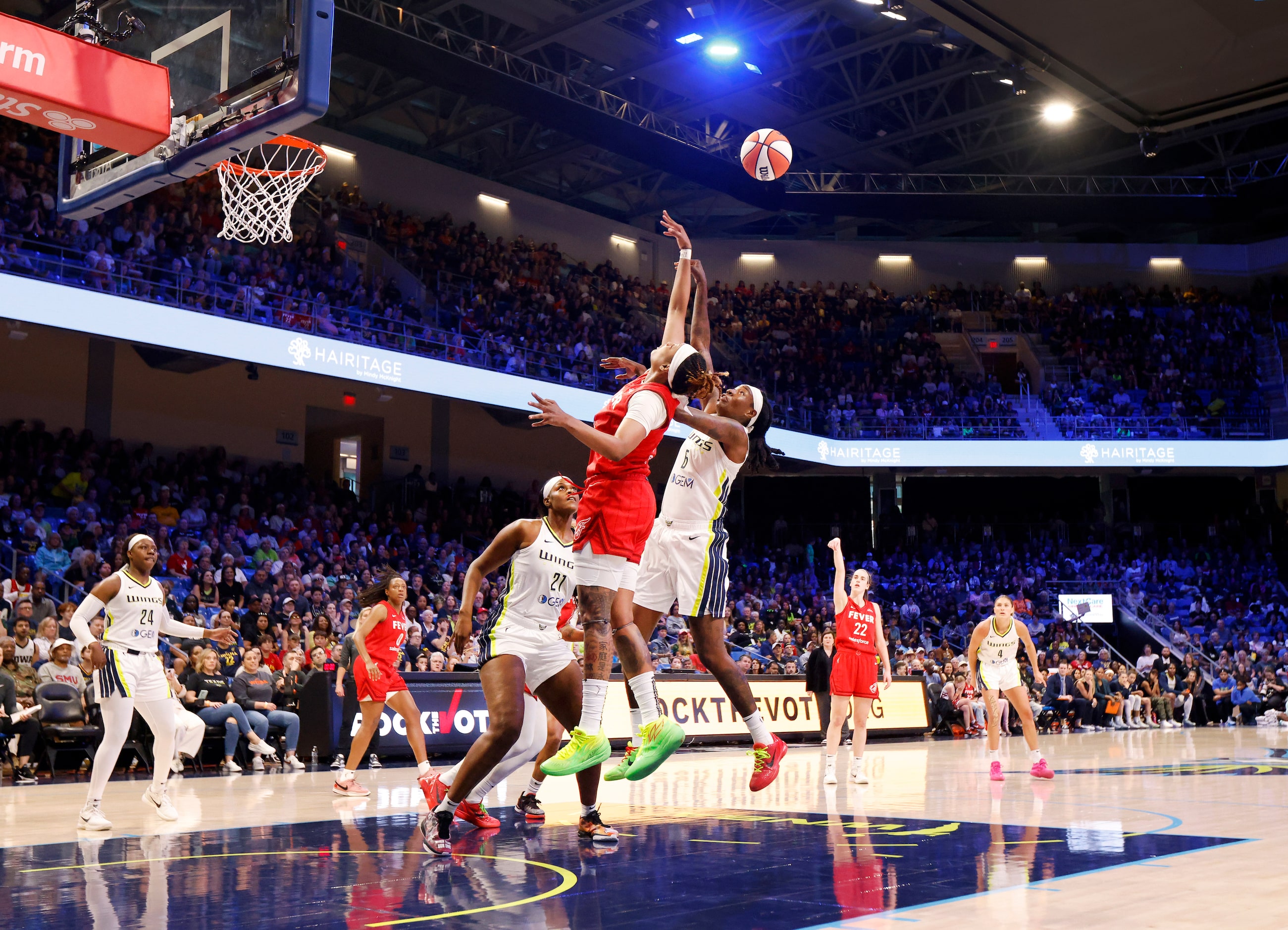 Dallas Wings forward Natasha Howard (6) and Indiana Fever forward NaLyssa Smith (1) battle...