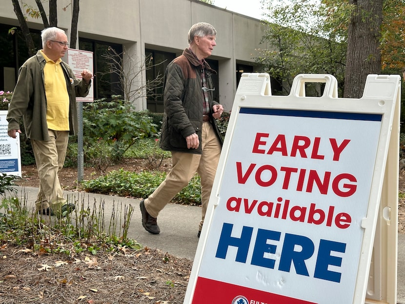 People leave after voting in the Atlanta suburb of Sandy Springs, Ga., on Tuesday, Oct. 15,...