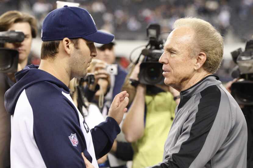 Dallas Cowboys quarterback Tony Romo and former quarterback Roger Staubach before the...