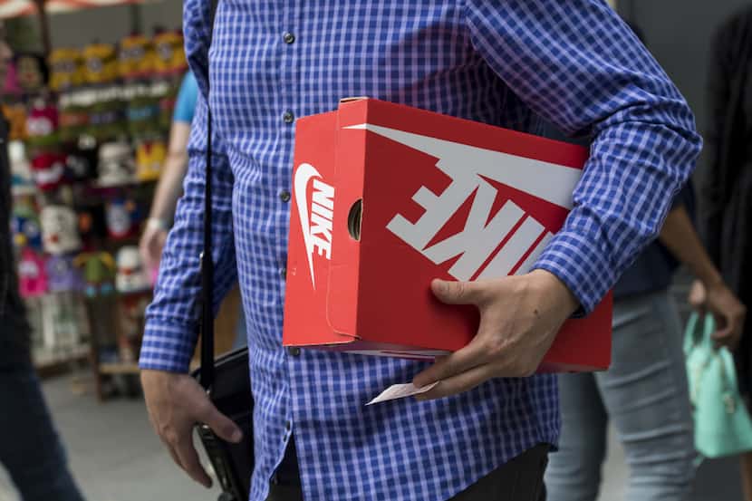 A shopper carries a Nike shoe box in San Francisco, Calif. 