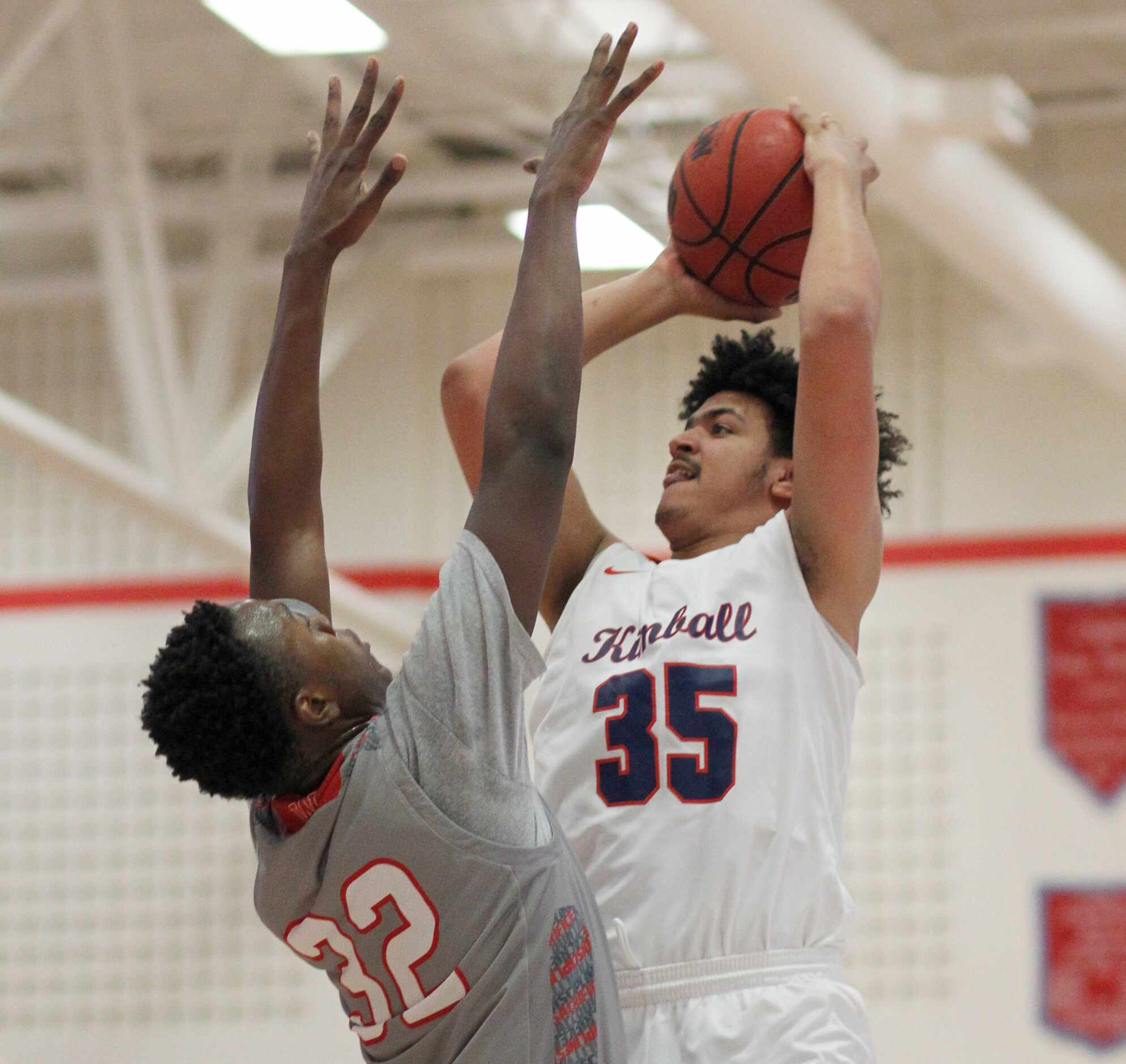 Dallas Kimball forward Aydan Blair (35) shoots as he is defended by Dallas Woodrow Wilson"s...
