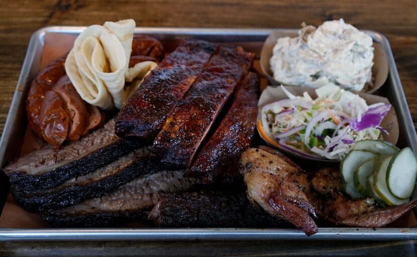 Brisket, spare ribs, tamale sausage, smoked quail, potato salad, and sorano slaw at Hurtado...